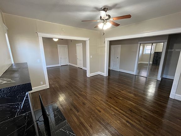 Living room with a view of the entryway with closets and a glimpse of the dining room