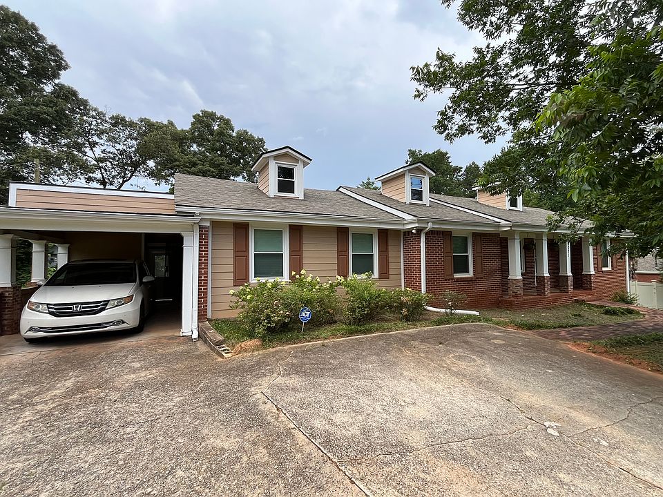 Front of home: one-car carport & driveway to fits four additional vehicles