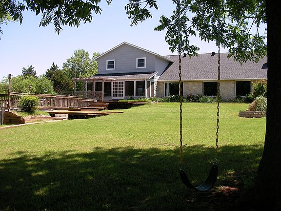 Large lot with screened-in porch and wood deck.