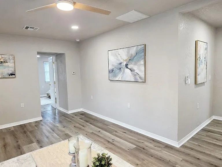 Living room with Kitchen view and Primary bedroom