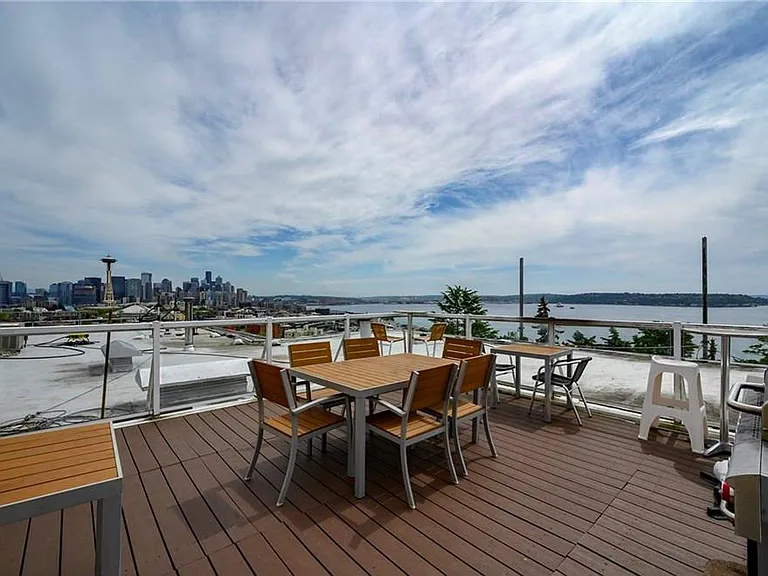 Rooftop deck with Space Needle centerpiece, Mount Rainier, Downtown, Elliott Bay, West Seattle & Alki, and Vashon Island.