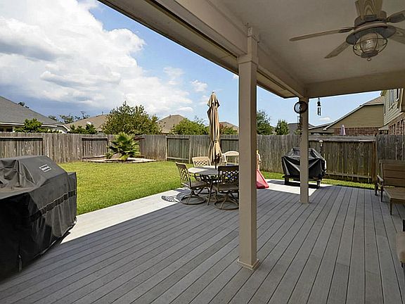 Step out the back door onto the lovely covered composite wood deck with ceiling fan, an open area, and a storage shed on the side yard that will stay.