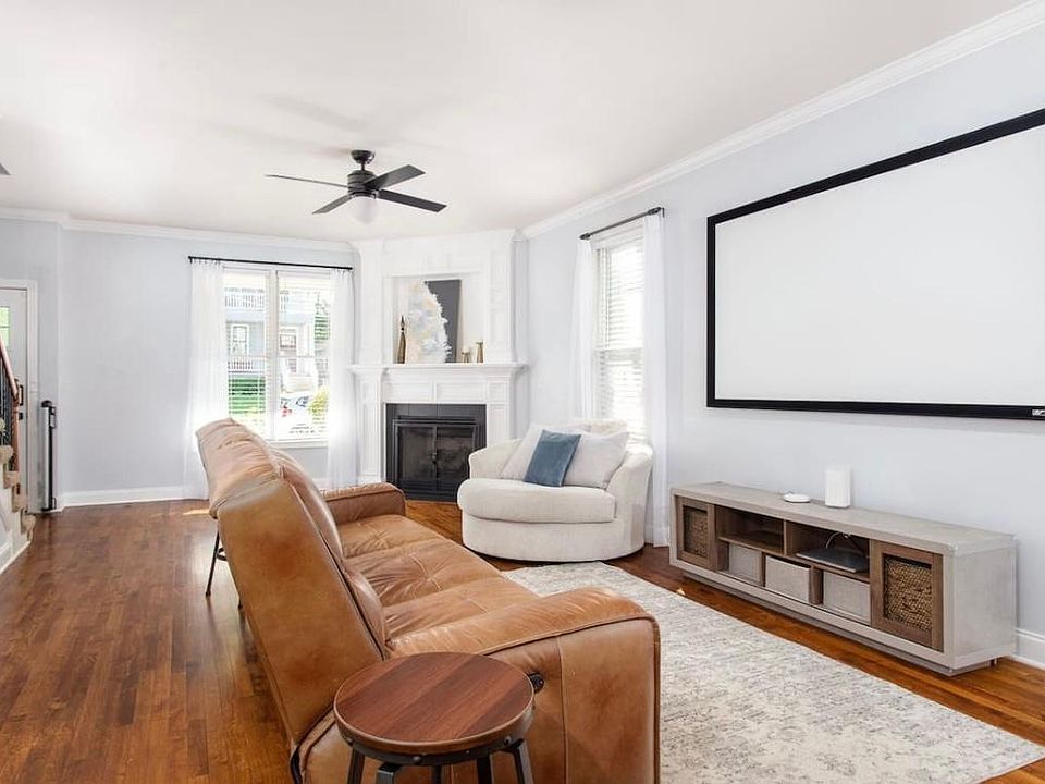 View of living room with 65" Roku Smart TV