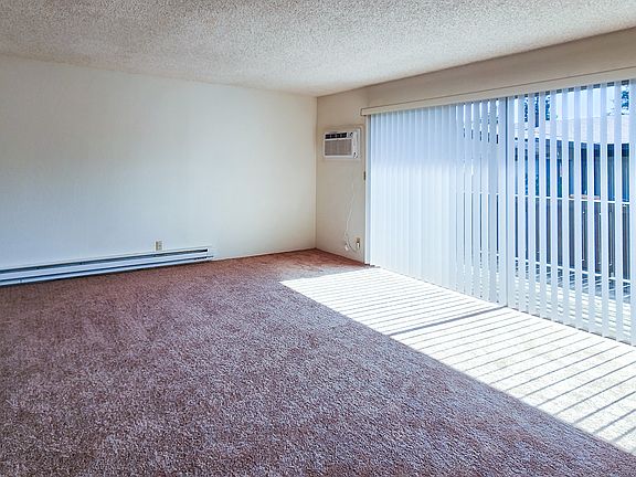 Spacious Livingroom with sliding door to deck. Brand New Wall Air Conditioner.