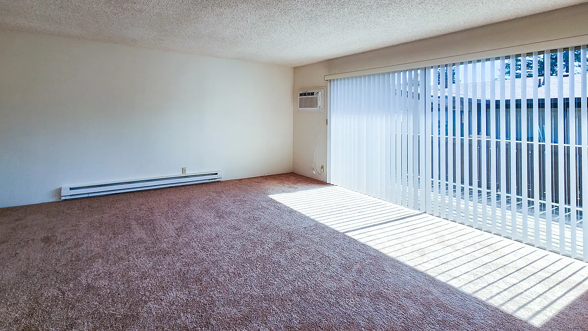 Spacious Livingroom with sliding door to deck. Brand New Wall Air Conditioner. - 46711 Crawford St