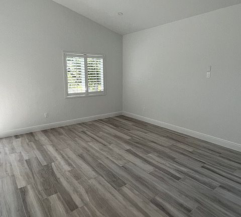 Main living area with vaulted ceiling.