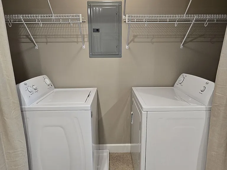 Washer and dryer included in unit adjacent to kitchen. Plenty of storage space and shelves.