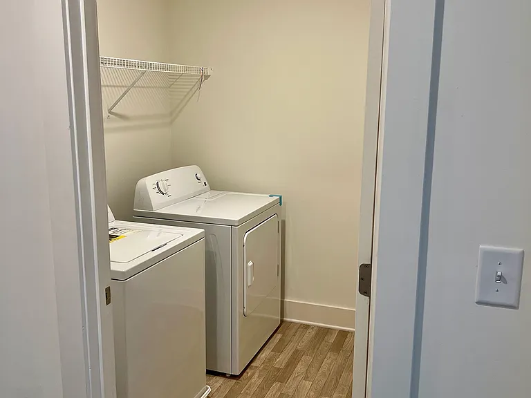Washer and dryer situated in a separate laundry room with convenient access to all three bedrooms