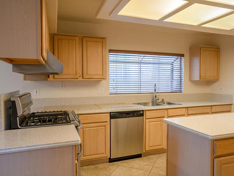 stove, dishwasher, sink, garbage disposal, and island