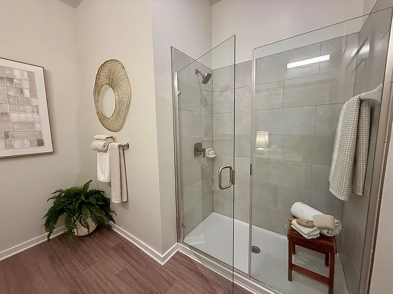 Integra Palms offer luxury in this beautifully designed bathroom, complete with a glass shower and elegant finishes.