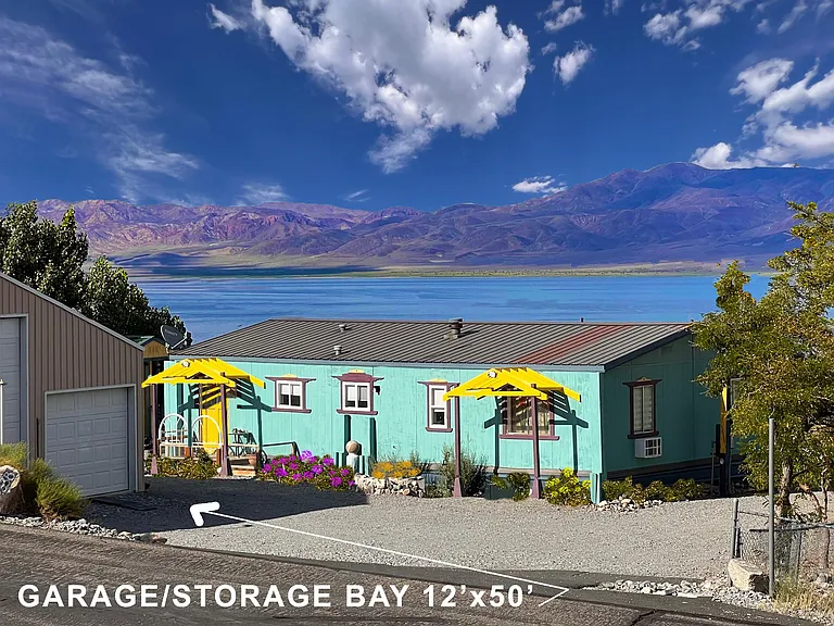 Outside home picture with garage bay and lake view