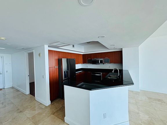 Open kitchen with stainless steel appliances and extra cabinets space