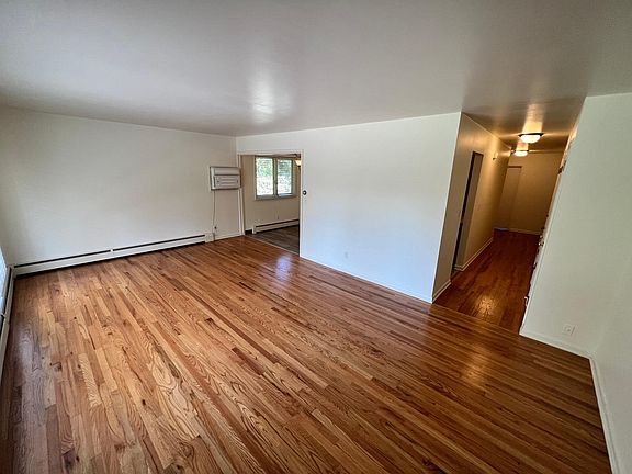 Living room looking from front door. Dining room off of kitchen and living room.