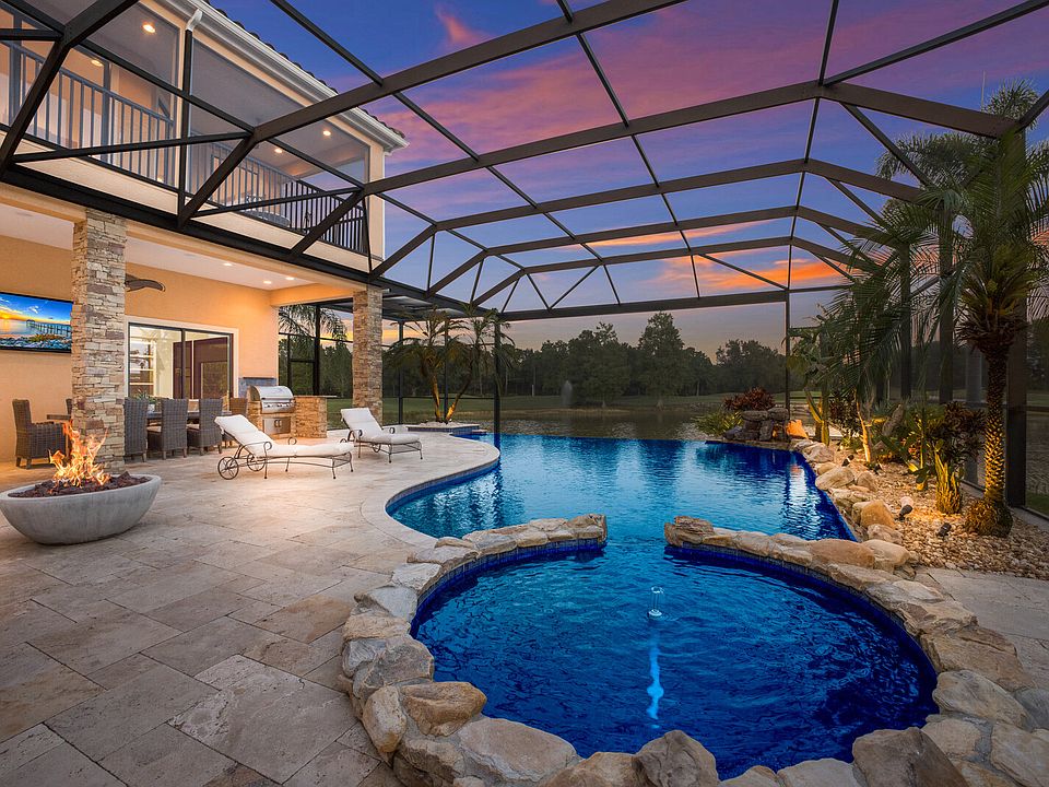 Outdoor area with large infinity-edge pool and panoramic screen