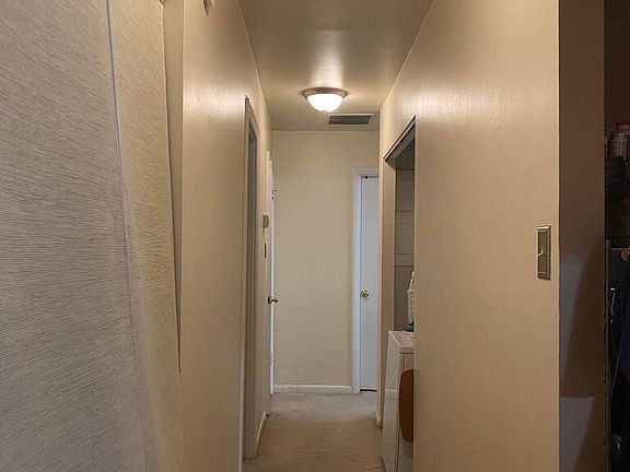 Hallway to access Hall Closet (Left), Kitchen Access (Right), Laundry Closet, Bedrooms, & Bathroom.