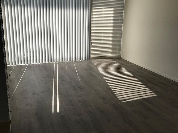 Living Room with hard wood floor with blinds.