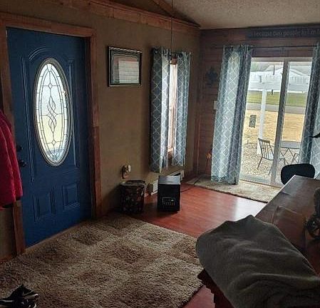 Den/sunroom/ entry to the home with cathedral ceilings.