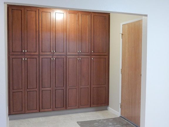 Floor to ceiling storage cabinets in front entry