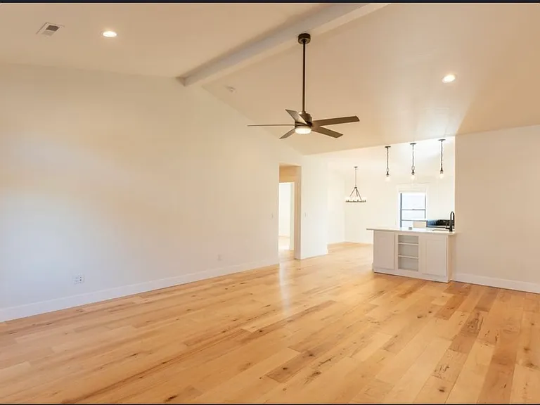 Entry view into open living room, kitchen & dining