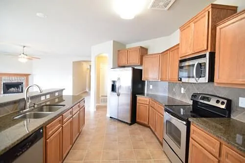 Well equipped kitchen with stainless steel appliances-new refrigerator, stove, microwave, dishwasher. disposal in double sinks & lots of cabinets and counters.