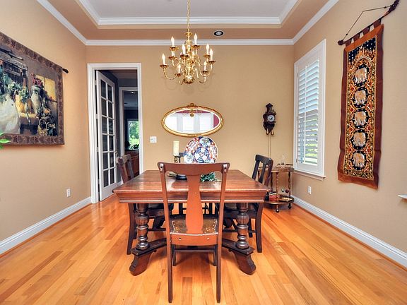 Formal Dining Room features Coffered Ceiling and French Door to Butlers Pantry