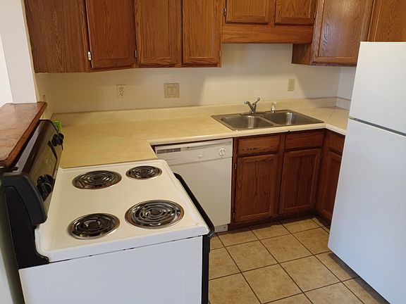 Kitchen provides ample shelf space for dishes, cookware and canned or packaged food. Range has self cleaning oven.