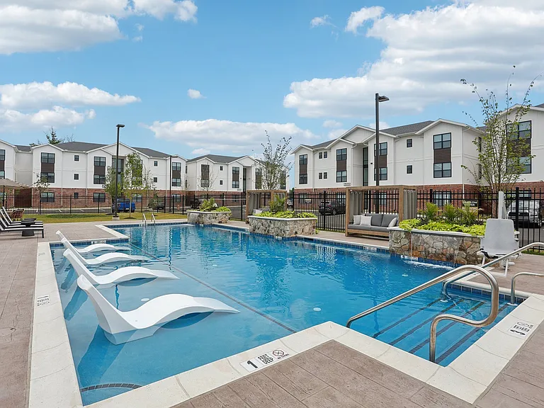 Resort style pool with sundeck and water features