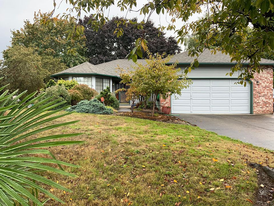 Nicely landscaped front yard with lawn, private front entrance - well-maintained one-level home.