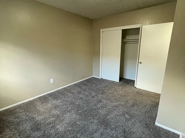 Smaller bedroom, perfect size for a queen size bed, full dresser as well as a small desk!