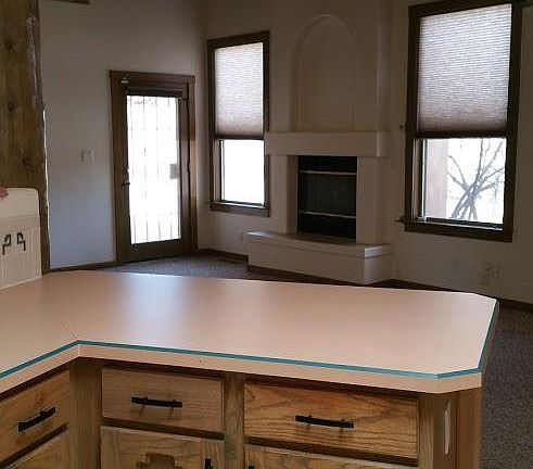 kitchen looking into living room with fireplace