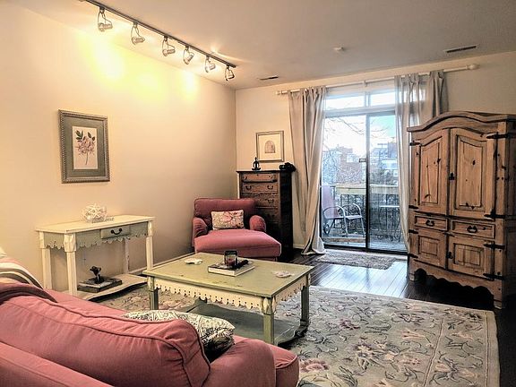 Living room looking outside, TV in cabinet.