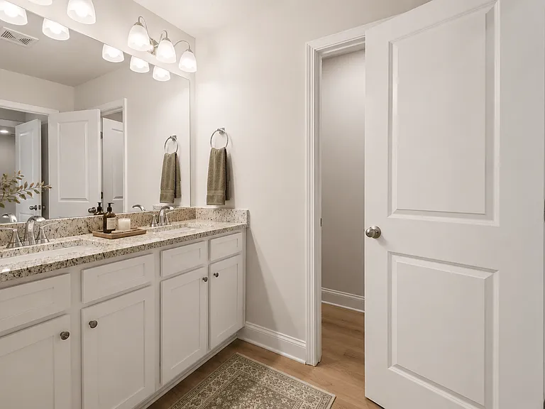 A spacious primary bath featuring dual vanities and ample room for your daily routine.