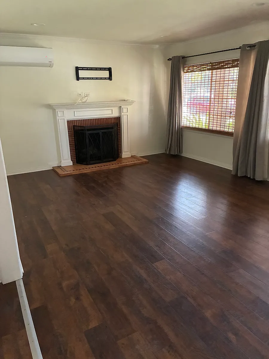Living Room with fireplace and A/C unit - 4440 Elrovia Ave #1