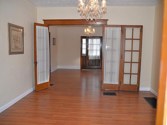 Crystal chandelier. New laminate flooring and all walls and baseboard freshly painted. Shared French doors with fireplace room.