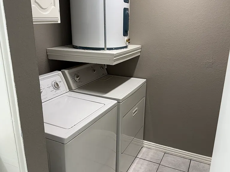 Separate laundry room with washer and dryer included