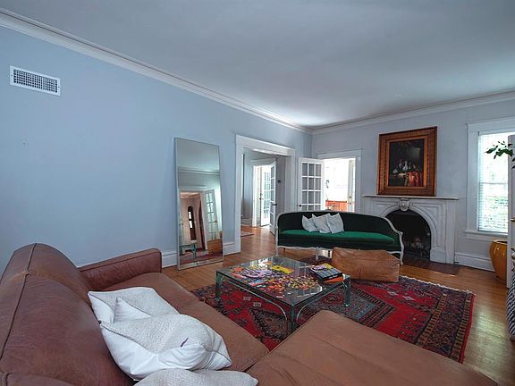 Living room with original marble fireplace, fitted for gas.