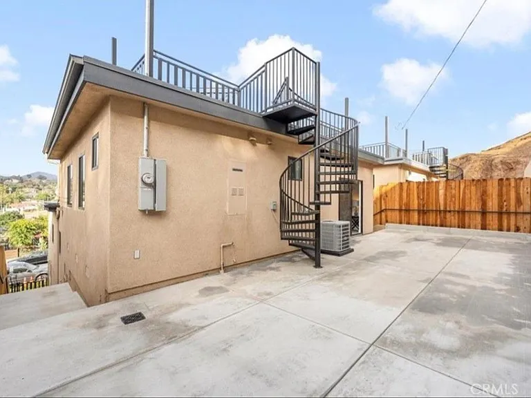 Spiral staircase leads up to rooftop deck
