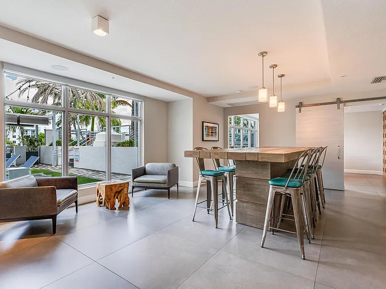 Clubroom with Community Table, Lounge Chairs, and Window Views