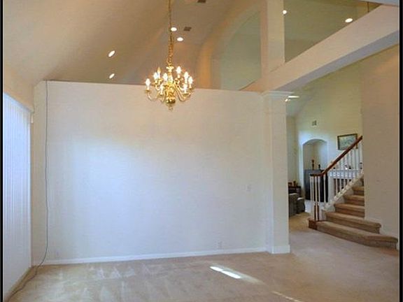 Formal dining room architectural flair with open ceilings and columns.