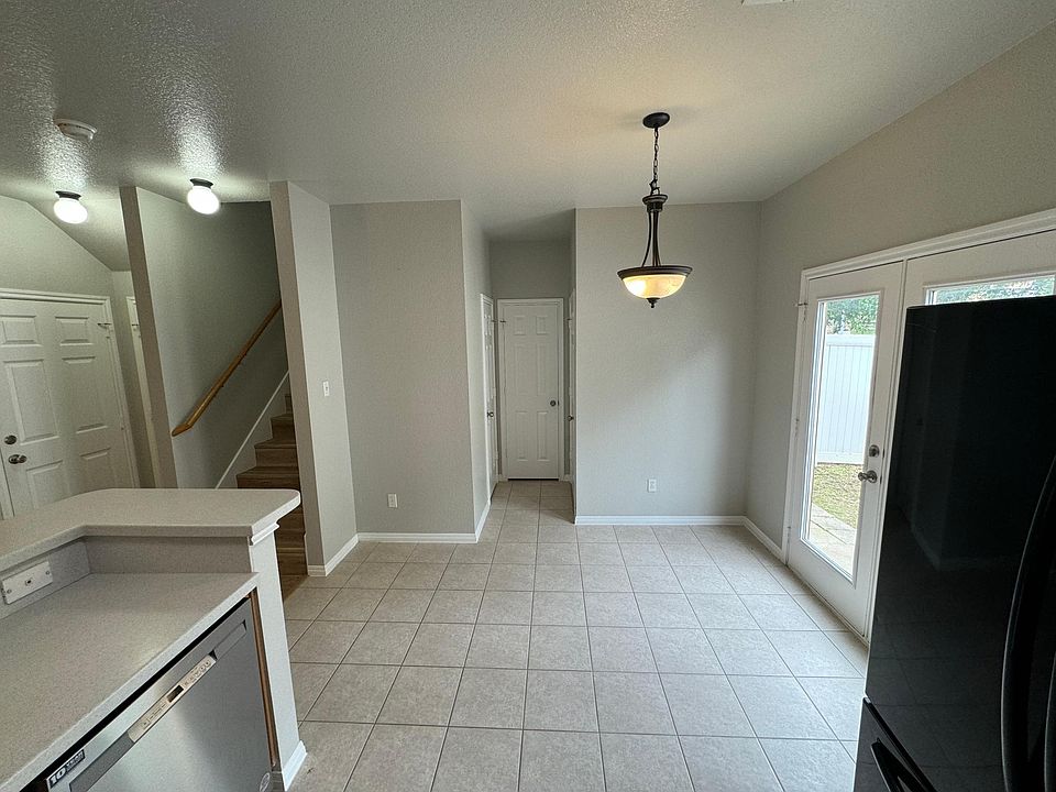 Kitchen view of upstairs and backdoor.