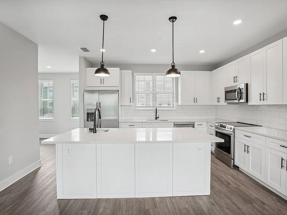 Open kitchen layout with all new stainless steel appliances, designer lighting, quartz countertops, wine storage, etc.