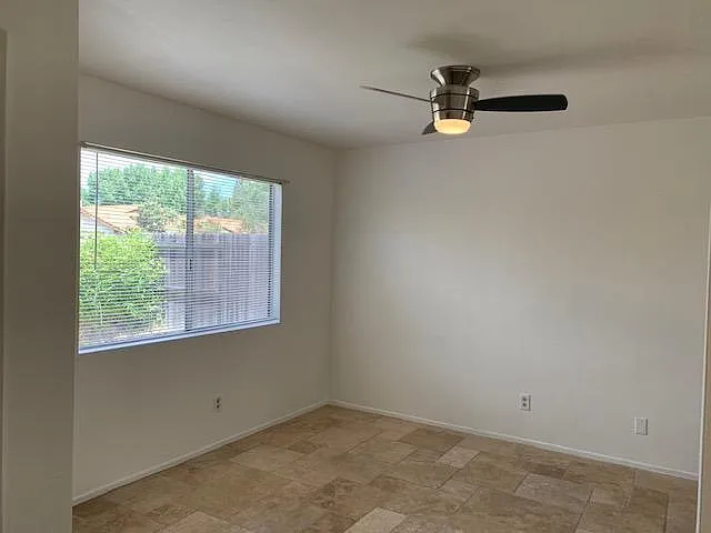 family room just off the kitchen with stone flooring