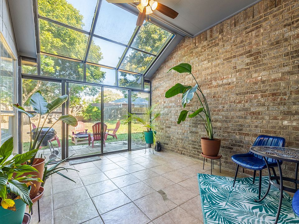 Tranquil solarium with large plants.