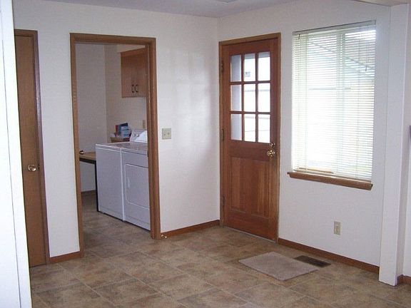 Main floor laundry room with 1/2 bath and laundry tub. Door from kitchen out to a large patio and backyard.