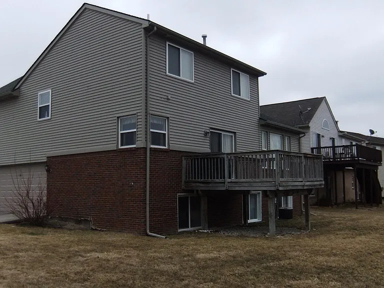 daylight basement windows, deck, side entry 3 car garage, corner window and kitchen sink