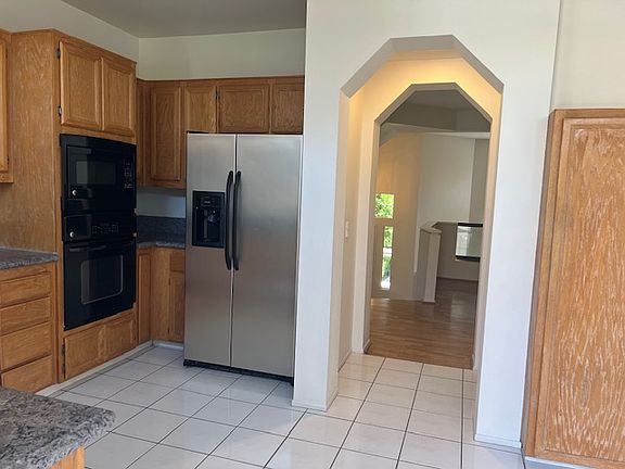 Kitchen with fridge and gas stovetop