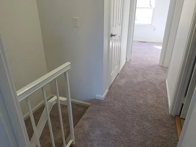 3rd floor hallways between sunny bedrooms. Large hallway closet with deep shelves on the left.
