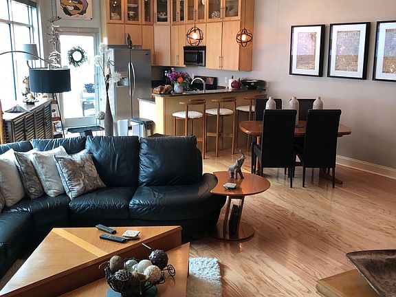 Open plan living area with large picture windows and electric blinds