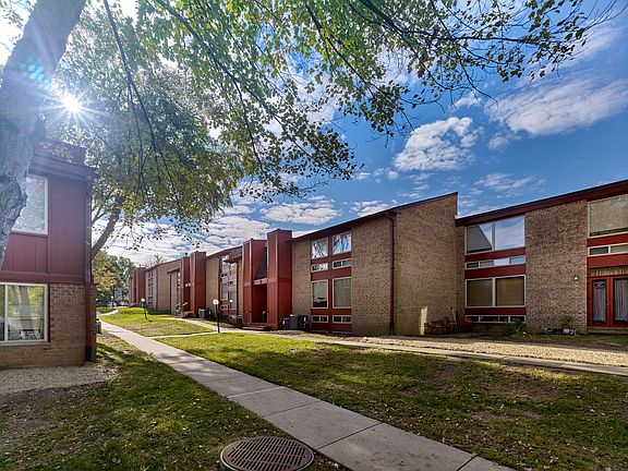 Enjoy the peaceful, tree-lined setting at North Crossing Apartments, featuring spacious brick buildings, open lawns, and inviting walkways throughout the community.