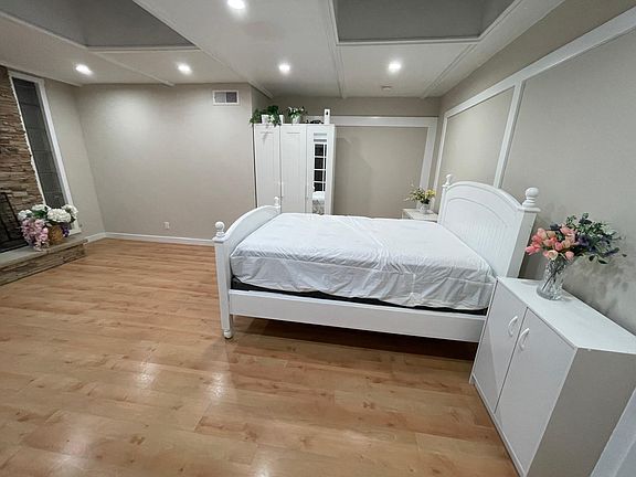 Spacious bedroom with wood flooring